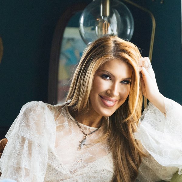 Kimberly Dawn, country artist, smiling in a white lace blouse